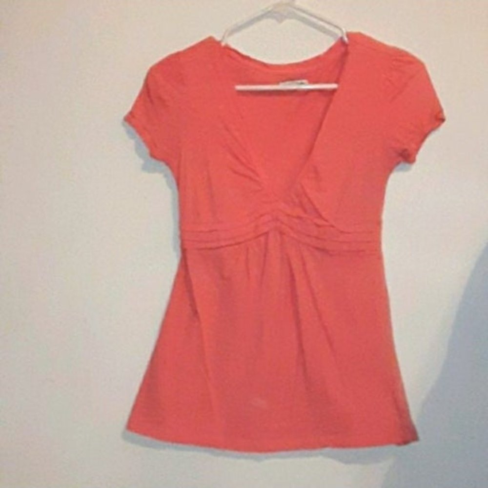 coral v-neck top.